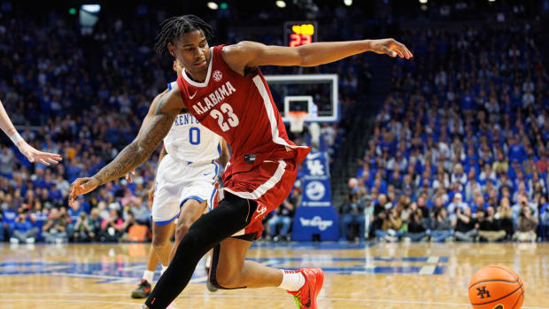 Feb 24, 2024; Lexington, Kentucky, USA; Alabama Crimson Tide forward Nick Pringle (23) looses control of the ball during the first half against the Kentucky Wildcats at Rupp Arena at Central Bank Center. Mandatory Credit: Jordan Prather-USA TODAY Sports  